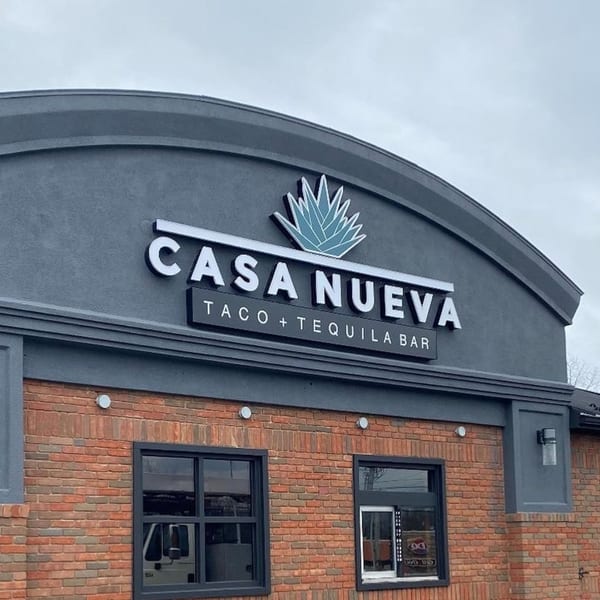 Exterior of Casa Nueva Mexican Restaurant Bar & Grill, featuring a brick facade and prominent signage.
